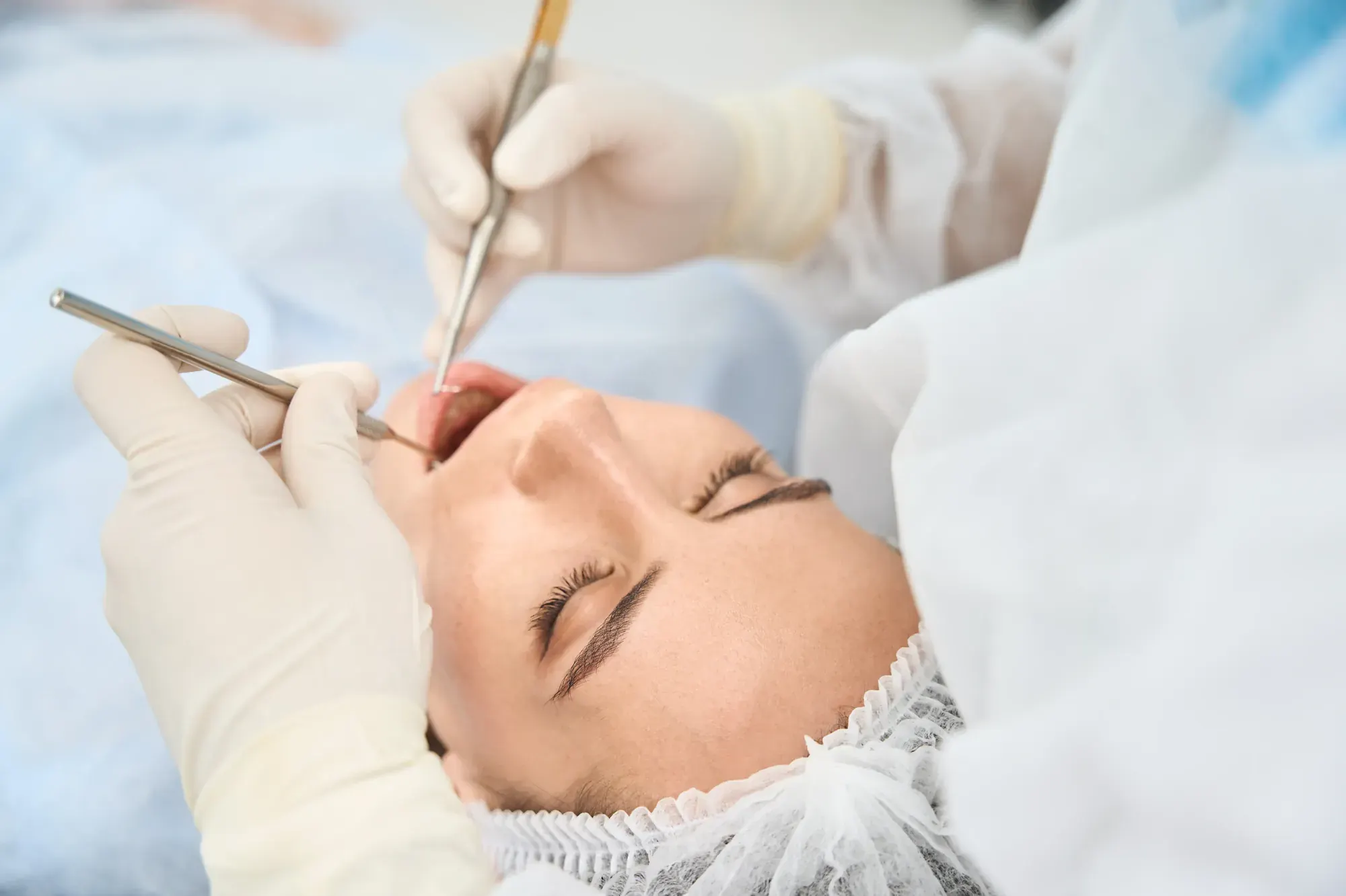 Relaxed patient in the dental chair during treatment to rebuild bone with a graft or sinus lift before dental implants