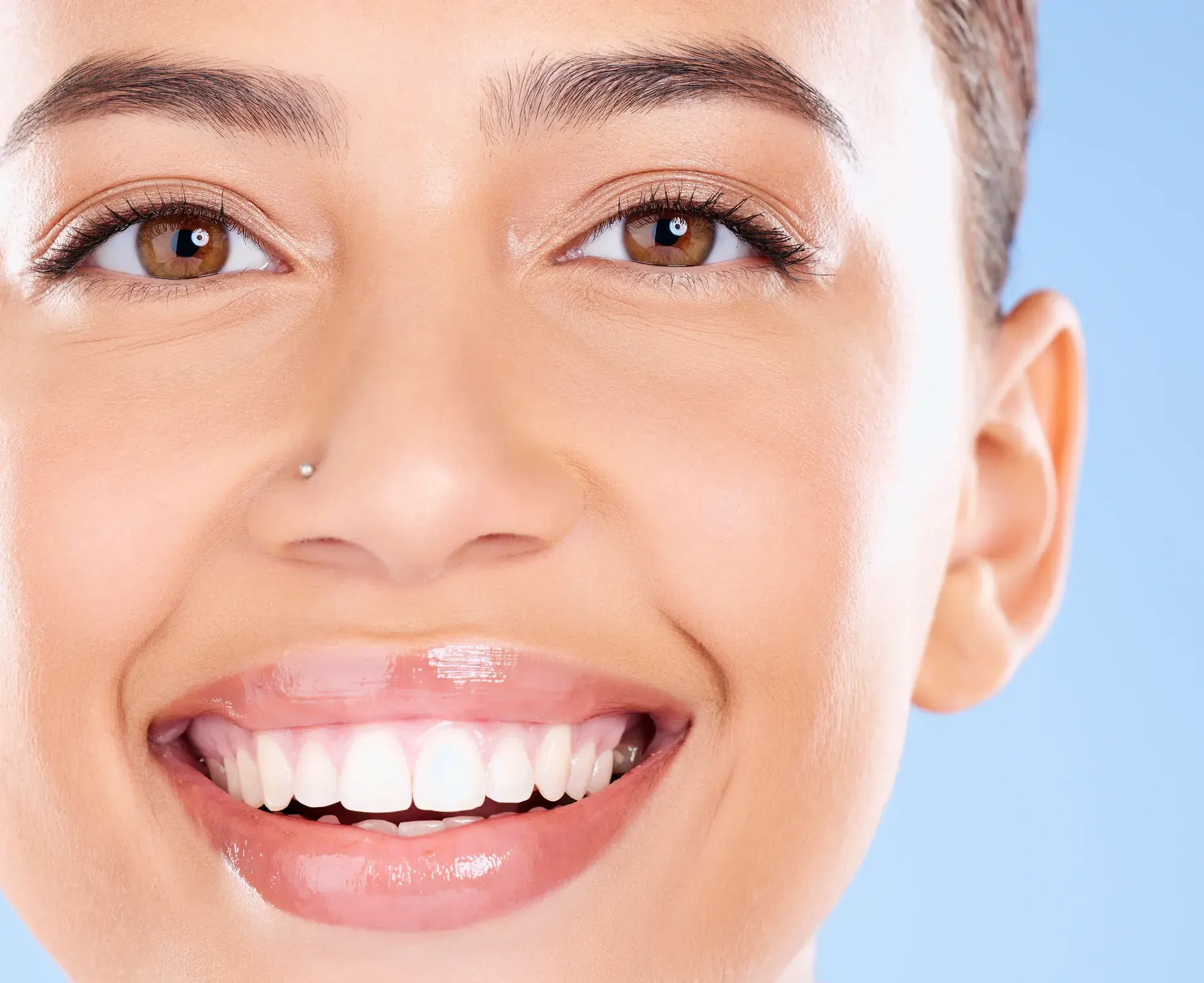 Close-up of a bright, even white smile, the natural-looking result porcelain veneers can create in Tribeca, NYC