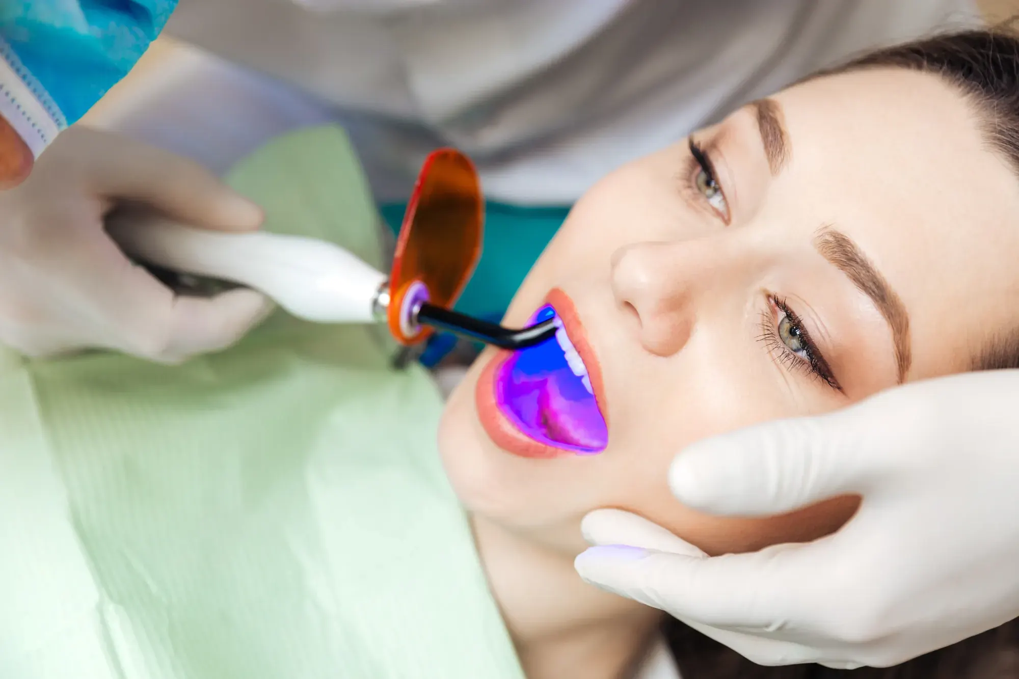 Patient relaxing under a professional light during in-office Zoom! teeth whitening at a Tribeca dental office