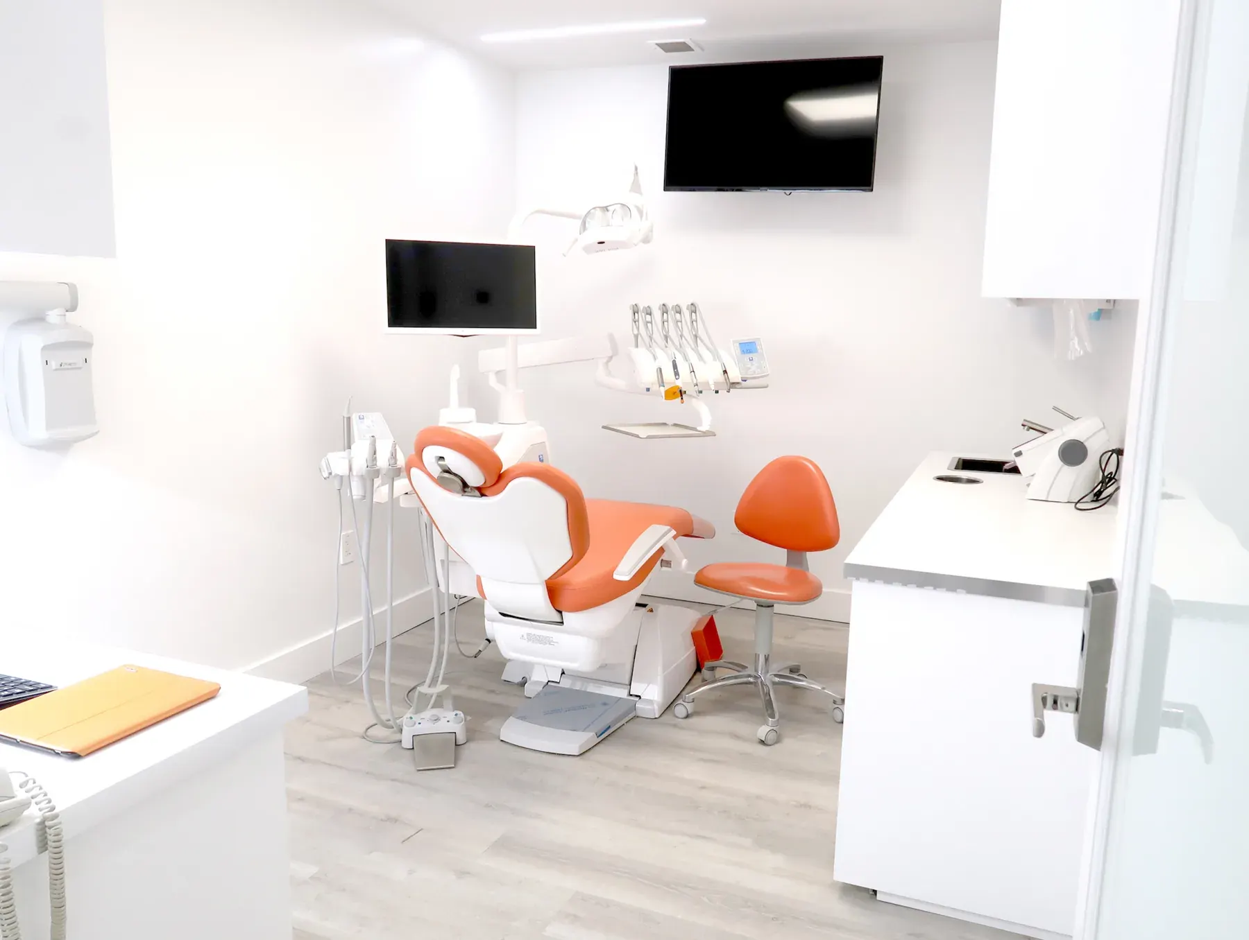 Treatment room with orange dental chair