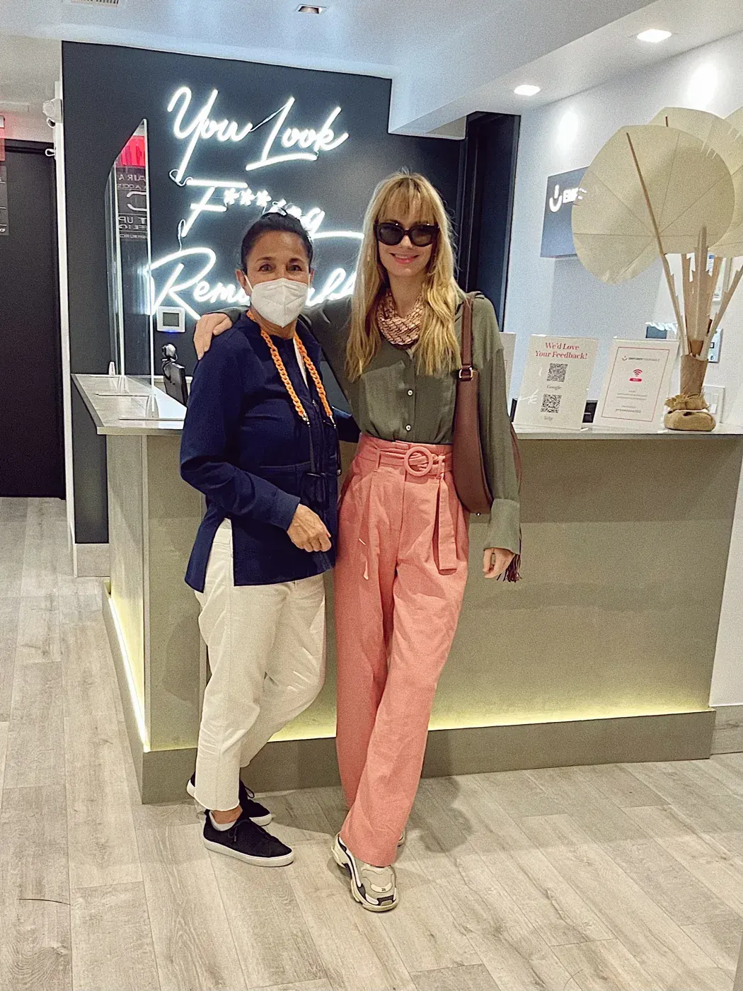 Dr. Moezinia with a happy patient at the front desk