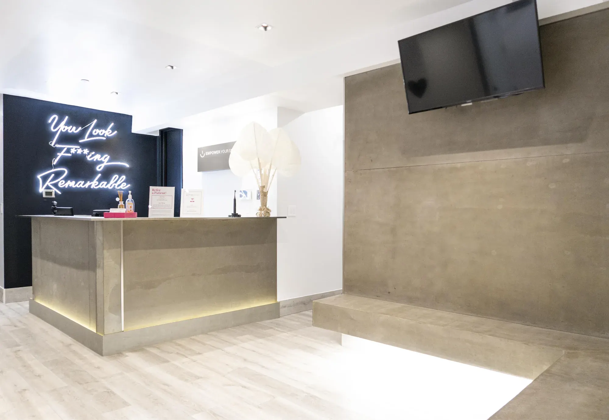 Reception and neon sign at Empower Your Smile, Tribeca